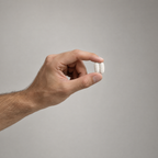 Hand holding two Anagen tablets