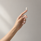 One Anagen tablet balanced on a fingertip