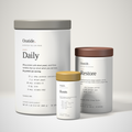 The Oratide 3-pack: the Daily canister, the Restore tub and the Roots capsule bottle together at true relative size, on a plain cream background.