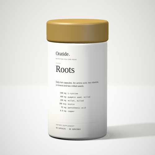 Oratide Roots, a white 60-capsule bottle with a brass cap, turned slightly and lit from the left on a pale surface.